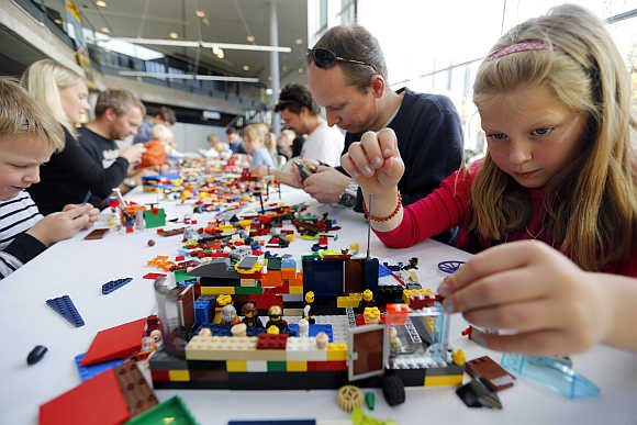Helene Haga, right, her father Trond, centre, and her brother Henrik, left, attend the annual Lego Festival in Oslo, Sweden.