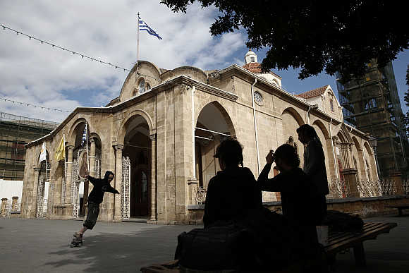 A boy skates in front of the Orthodox Faneromeni church in central Nicosia, Cyprus.