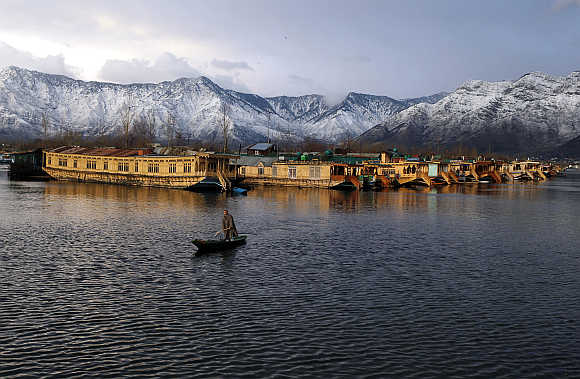 A man rows his boat in Dal Lake in Srinagar, India.