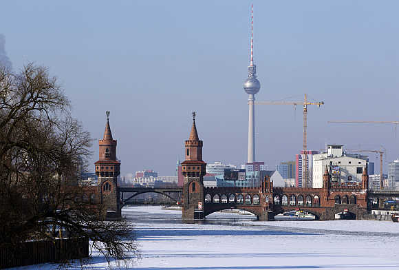 A view shows the cityscape and the frozen river Spree on a cold winter day in Berlin, Germany.