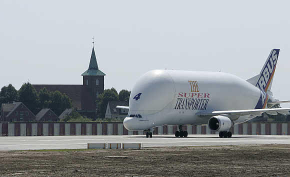An Airbus Beluga transport plane passes the church of Neuenfelde as it turns at the end of the runway at the Airbus facility in Finkenwerder near Hamburg in Germany.