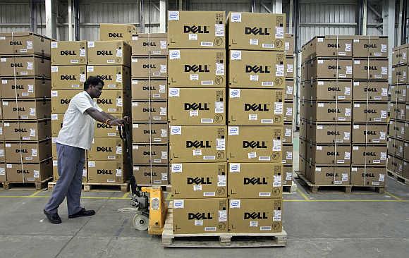 A man pushes a trolley full of Dell computers in Sriperumbudur Taluk, Kancheepuram district, Tamil Nadu.