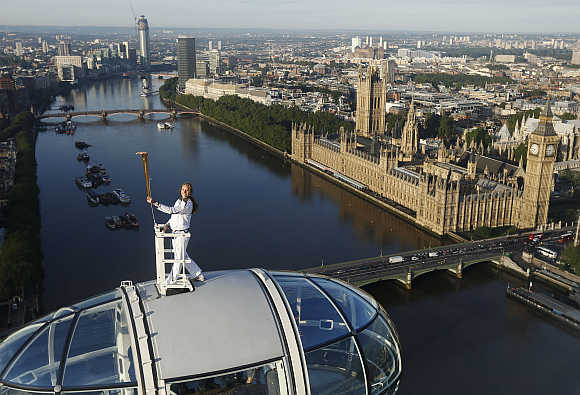 Torch bearer Amelia Hempleman-Adams stands on top of a capsule on the London Eye in the United Kingdom.