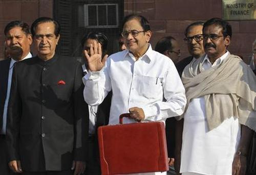 Finance Minister P. Chidambaram (C) leaves his office to present the 2013-14 Union Budget.
