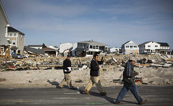 Men survey the damage caused by Hurricane Sandy in the Ortley Beach area of Toms River, New Jersey, United States.