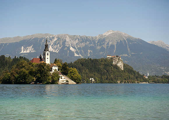 A church on Bled island and a castle are seen on Lake Bled in Slovenia.