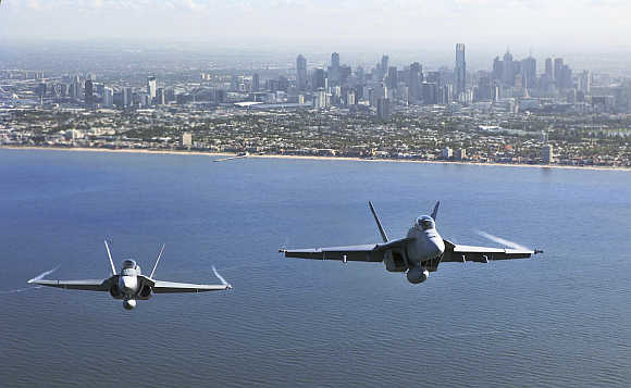Two Royal Australian Air Force fighter jets fly over Port Philip Bay as part of the International Airshow in Melbourne, Australia.