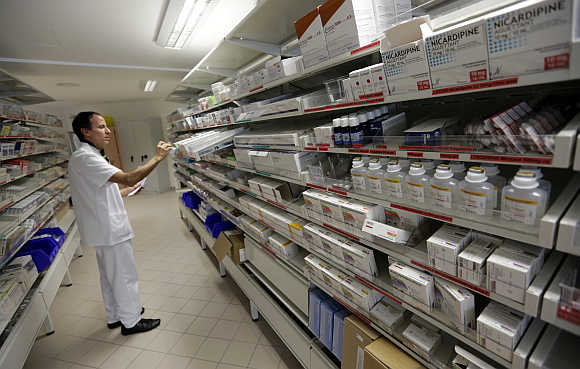A pharmacist selects drugs in Nice, France.