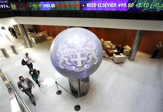 People walk through the lobby of the London Stock Exchange.