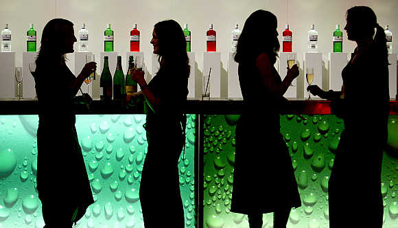 Women in silhouette as they drink at a party in a bar in central London.