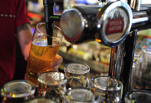 A barman pulls a pint of beer at a public house in Leeds, northern England.