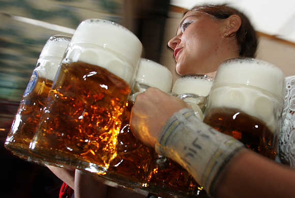 A waitress serves one-litre beer mugs at Munich's Oktoberfest, Germany.