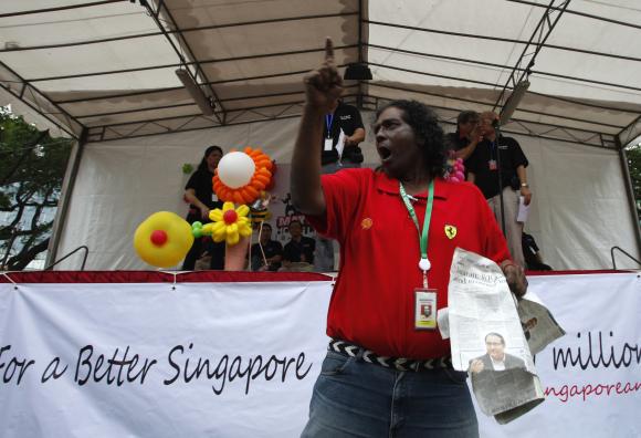Robertson Fernandez, 61, interrupts speakers during a May Day protest against against high living costs and immigration policies at Hong Lim Park in Singapore.