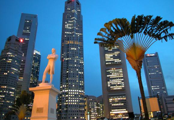 Singapore's skyline rises over a statue of Sir Stamford Raffles.