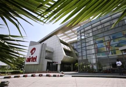 An employee stands in front of the Bharti Airtel zonal office building in Chandigarh.