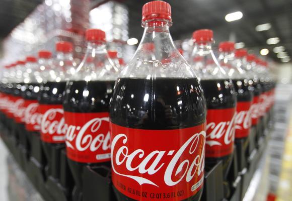 Bottles of Coca-Cola are seen in a warehouse.