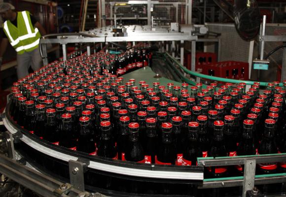 Bottles of Coca-Cola are seen on the production line at their bottling plant.