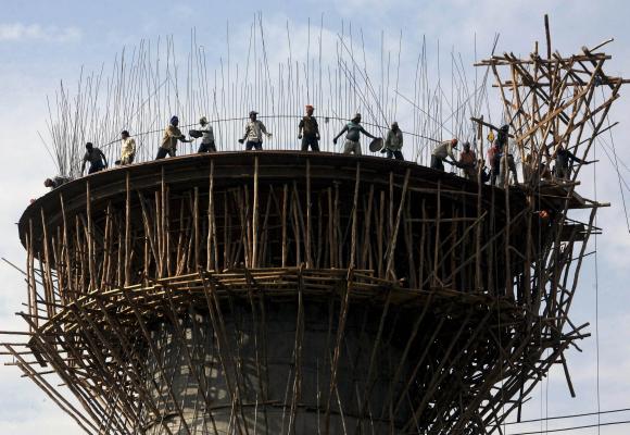 Labourers work on the construction of a water tank in Jammu.