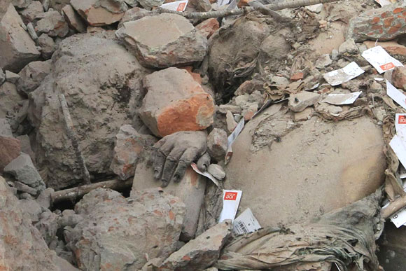 The hand of a garment worker is seen among the rubble of the collapsed Rana Plaza building in Savar.