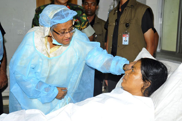 Bangladesh's Prime Minister Sheikh Hasina comforts a garment worker as she visits the survivors of the collapsed Rana Plaza building at a hospital, in Savar.