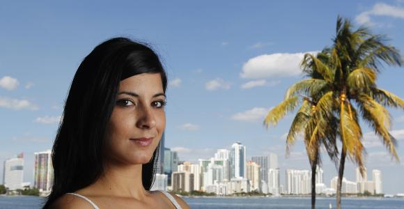 Cuban immigrant Ana Soto poses during a photo session with the Miami skyline in the background.
