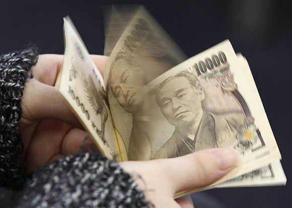 A woman counts Japanese 10,000 yen notes in Tokyo, Japan.