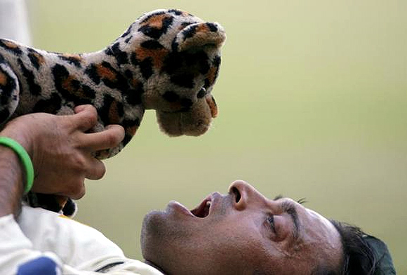 Pakistan's Shoaib Akhtar holds a stuffed toy at the end of the fourth day's play of their third and final test cricket match against India in Bangalore.