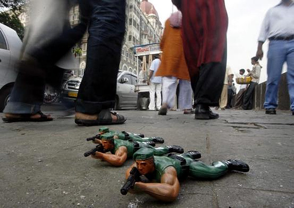 Toy soldiers are displayed for sale by a street hawker in front of the Taj Mahal Hotel.