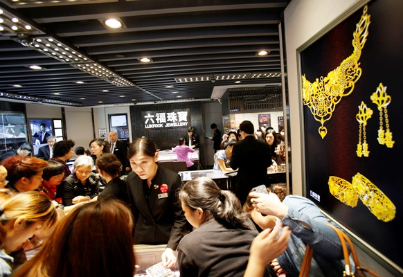 Attendants serve customers inside a jewellery store at Hong Kong's Mongkok district.