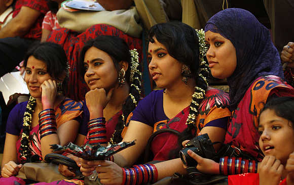 People watch a puppet show as they celebrate Pohela Boishakh, the first day of Bengali new year, in Dhaka, Bangladesh.