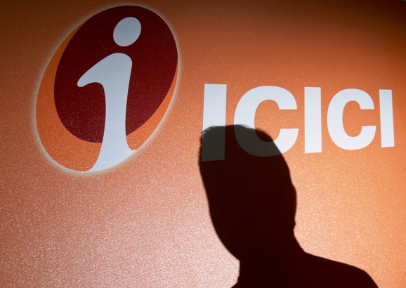 An employee's shadow is cast on the ICICI Bank logo at their headquarters in Mumbai.