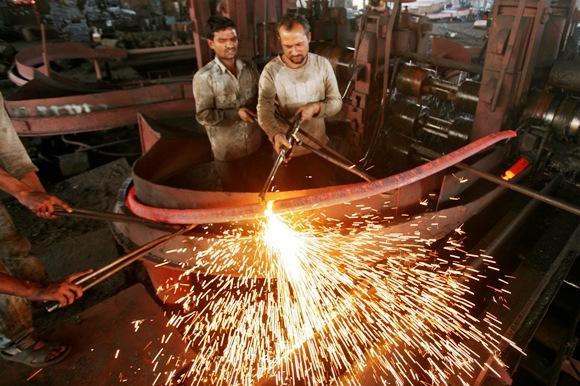 Labourers work inside an iron factory on the outskirts of Jammu.