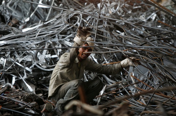 A labourer works inside a steel factory on the outskirts of Jammu.