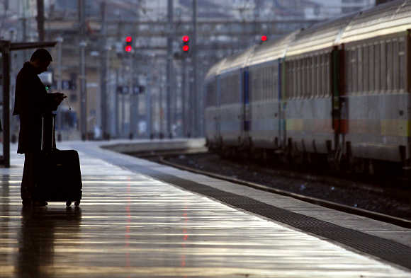 A commuter waits for a train at the Marseille's railway station in France.