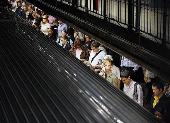 Commuters wait for a subway train in New York City, United States.