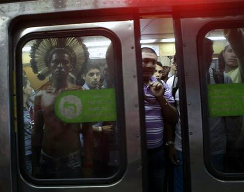 An indigenous man stands in a subway train in Rio de Janeiro.