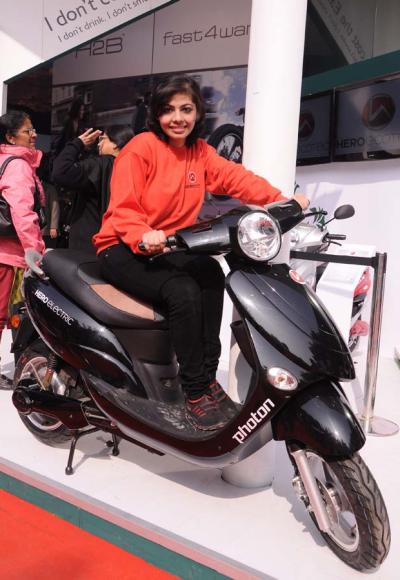 A model sits of Hero Electric's two-wheeler.