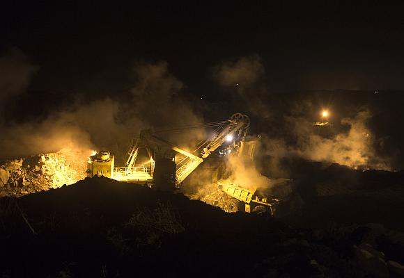 A truck is loaded with top soil at the Jharia burning coal field at Dhanbad district.