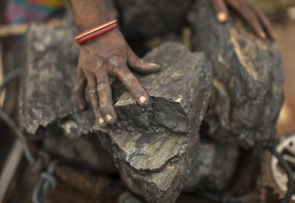 A local woman prepares to carry coal at an open coal field at Dhanbad district.