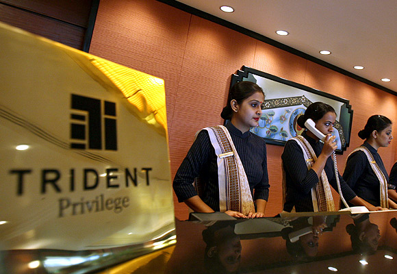Employees stand at the reception counter of the Trident-Oberoi hotel.