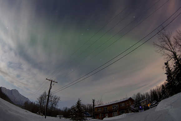 Aurora Borealis is pictured above a house along the Old Glenn Highway, Alaska, United States.