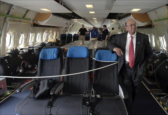 Boeing India President Dinesh Keskar (R) poses as flight technicians work inside the Boeing 787 Dreamliner aircraft for All Nippon Airways (ANA) after its India debut landing at the Indira Gandhi international airport in New Delhi.