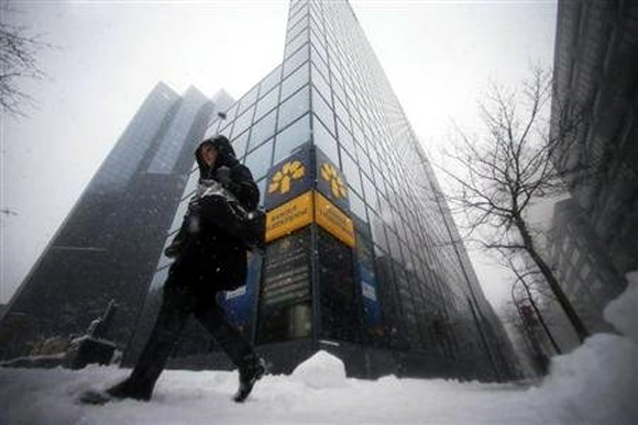 A pedestrian walks past the head offices of Laurentian Bank in Montreal.