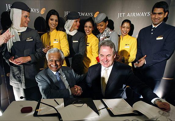 India's Jet Airways Chairman Naresh Goyal (L) and James Hogan (R) of United Arab Emirates Etihad Airways shake hands.