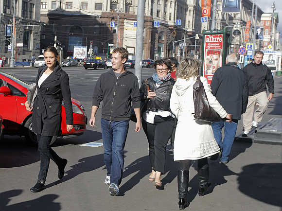 Facebook CEO Mark Zuckerberg, second left, walks on his way from a cafe to a hotel in Tverskaya Street in central Moscow, Russia.