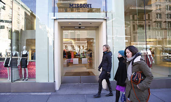 Women walk past a Missoni store on Madison Avenue in New York City, United States.