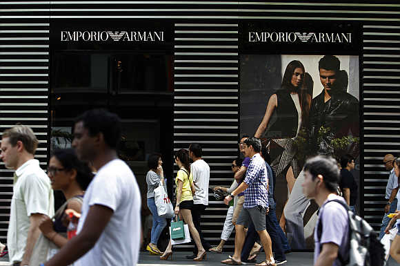 People walk past an Emporio Armani store on downtown Orchard Road in Singapore.