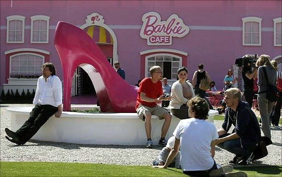 People relax outside the Barbie Dreamhouse.