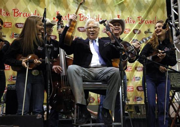 Berkshire Hathaway Chairman Warren Buffett waves his ukulele with The Quebe Sisters Band at the Berkshire Hathaway annual meeting in Omaha.