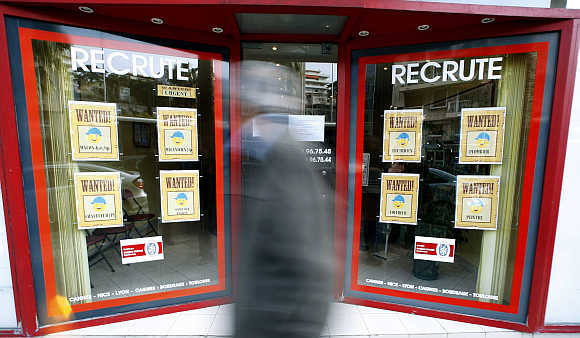 A man walks past an employment agency in Nice, France.
